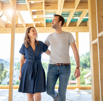 Husband and wife walking through pre-built home